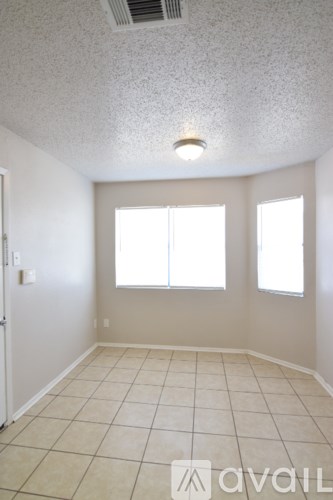 A room with a tiled floor and a window.