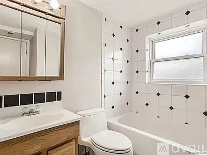A white toilet sits next to a sink in a bathroom.