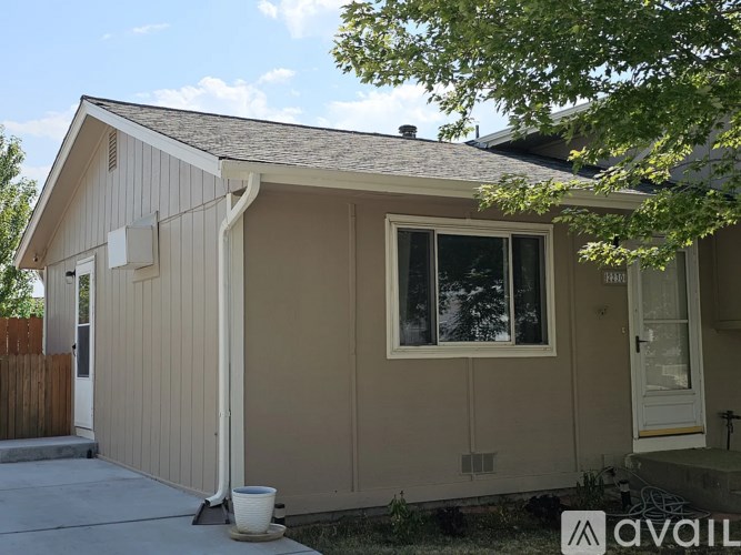 A small house with a brown roof and a white door is for sale.