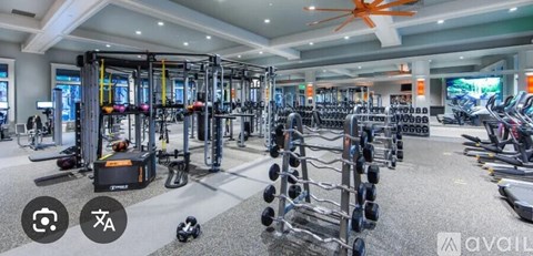 A gym with a variety of equipment including weights and machines.