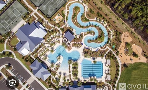 A bird's eye view of a resort with a large pool and a water slide.