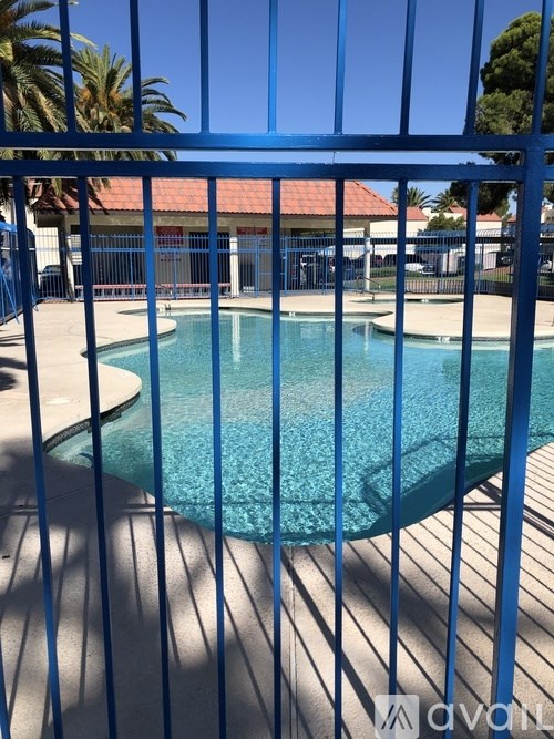 A pool surrounded by a blue fence.
