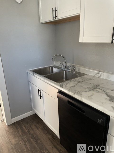 A kitchen with a sink and a dishwasher.