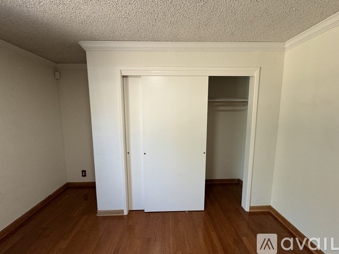 A room with a white door and a white wall.