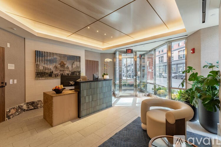 A reception area with a wooden desk and a chair.