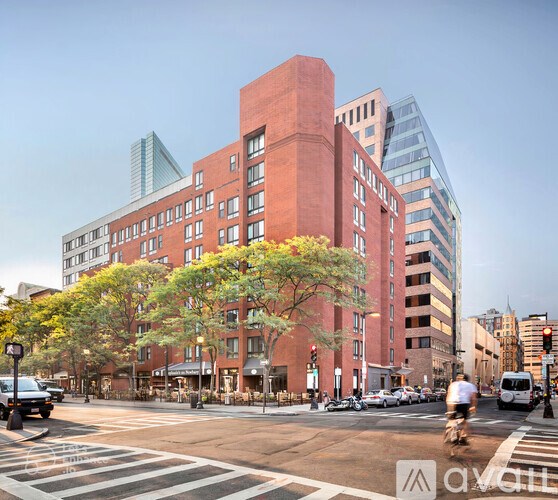 A man is riding a bicycle across a crosswalk in a city.