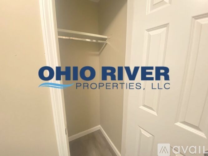 A hallway with a door and a logo for Ohio River Properties, LLC.