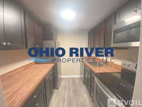 A kitchen with a wooden countertop and a logo that reads "OHIO RIVER PROPERTIES LLC".