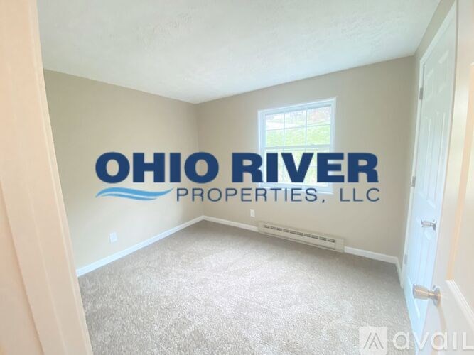 A room with carpeted floor and a wall decal that says "Ohio River Properties, LLC".