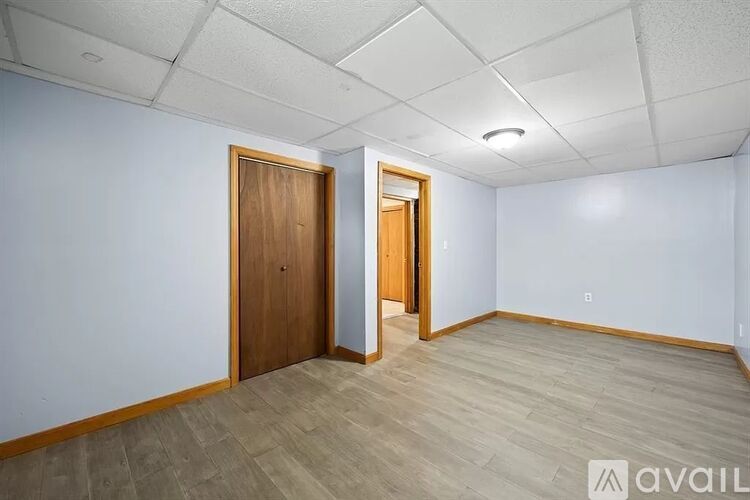 A room with a wooden door and a wooden floor.