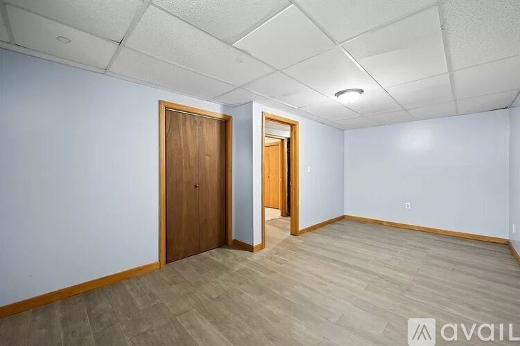 A room with a wooden door and a wooden floor.