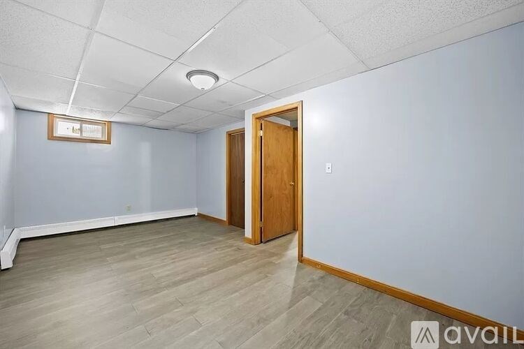 A room with a wooden door and a white ceiling.