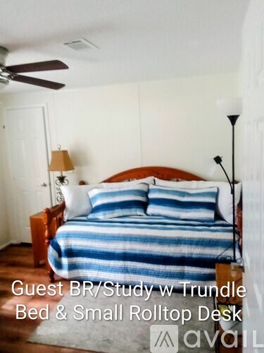 A bedroom with a bed and a small desk.