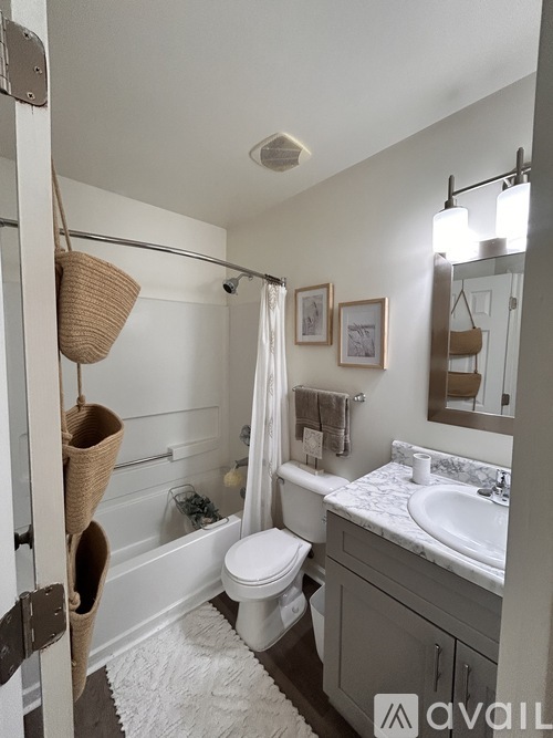 A bathroom with a white toilet, a white sink, and a white bathtub.
