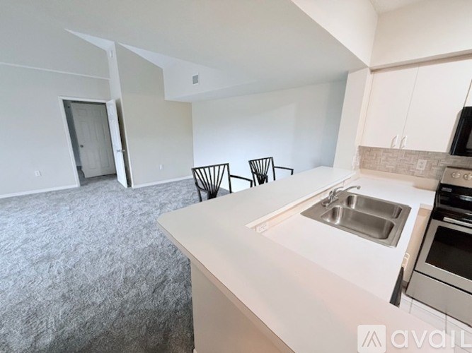 A kitchen with a sink, stove, and oven is available for rent.