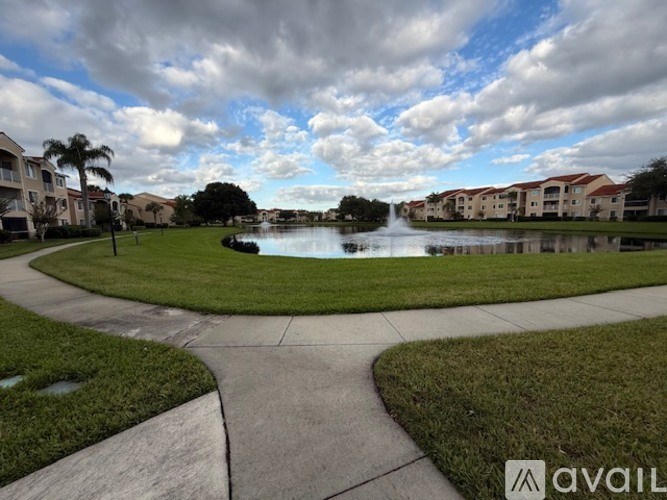 A residential area with a pond and houses.