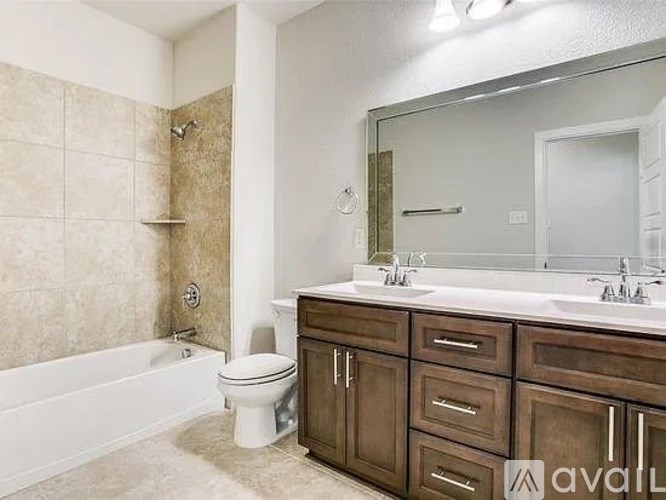 A bathroom with a toilet, sink, and bathtub.