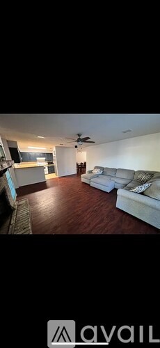 A living room with a couch and a television.