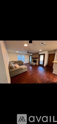 A living room with a couch and a television.