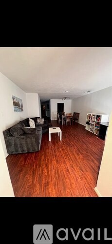 A living room with a grey couch and a white coffee table.
