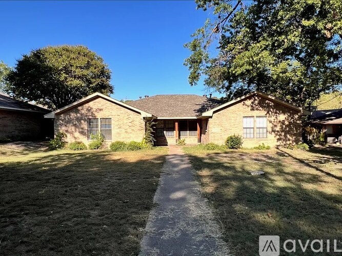 A house with a driveway in front of it is for sale.