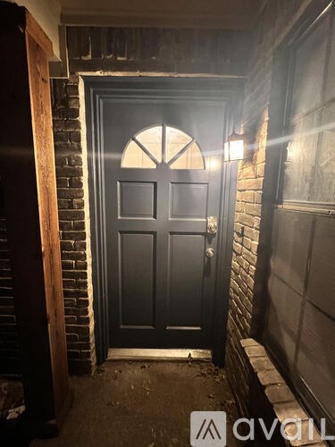 A black door with a mat in front of it.