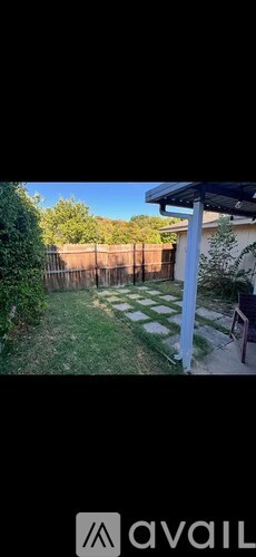 A backyard with a white and black checkered pattern on the ground.
