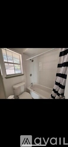 A bathroom with a toilet, sink, and bathtub.