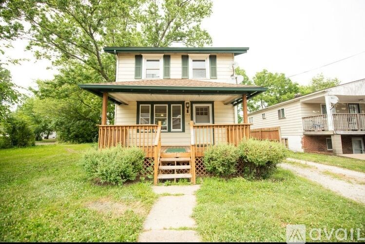 A house with a green roof and a porch.