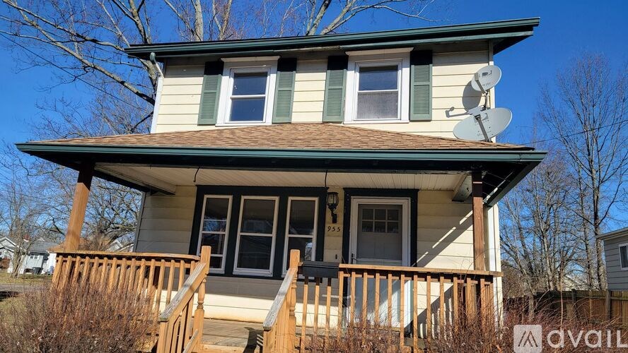 A house with a satellite dish on the roof.