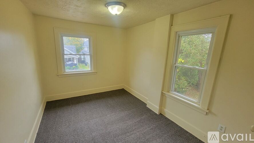 A room with a window on the left and a window on the right.