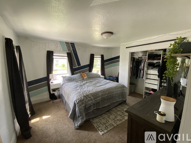A bedroom with a bed, a dresser, and a mirror.