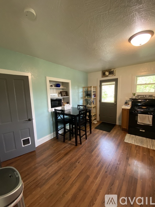A kitchen with a table and chairs in the middle of the room.