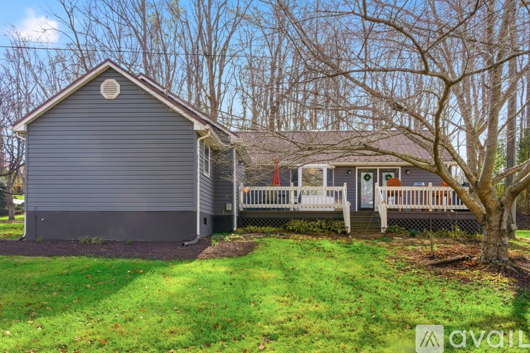 A house with a grey roof and a white fence.
