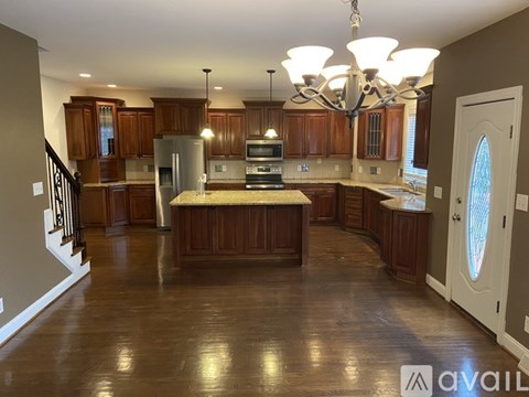 A large kitchen with wooden cabinets and a center island.