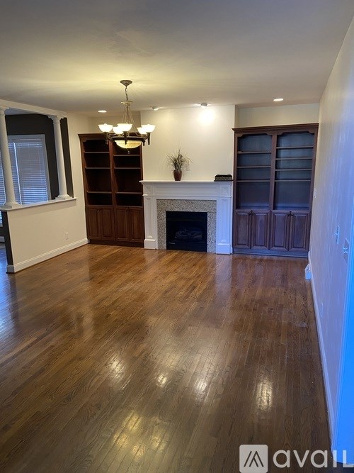 A room with a ceiling fan and a window with blinds.