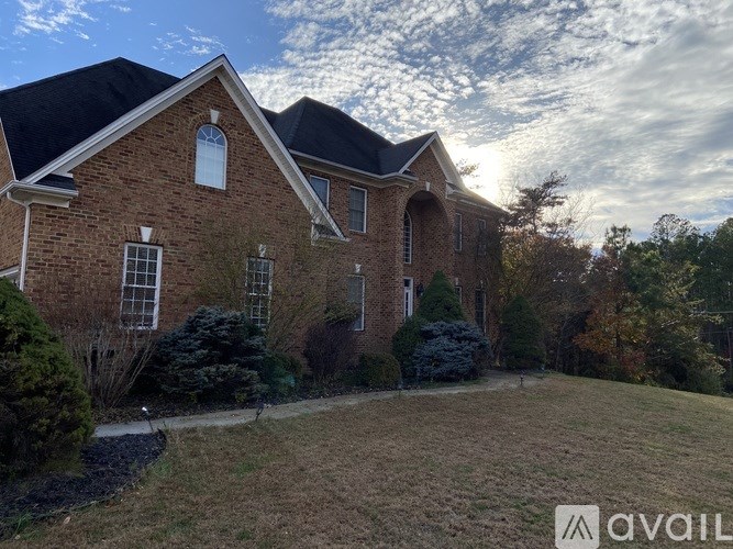 A kitchen with brown cabinets and granite countertops.