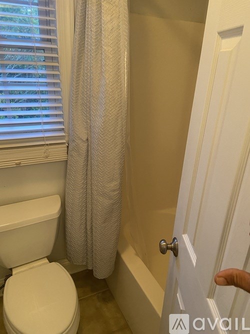 A person is opening a white door.