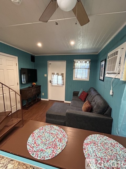 Living room with a grey couch and a brown coffee table.
