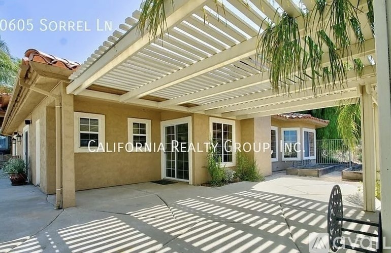 A house with a porch and a sign that says California Realty Grouping.