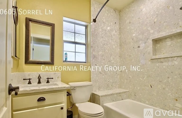 A bathroom with a toilet, sink, and tub.