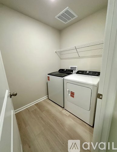 A small laundry room with a washer and dryer.