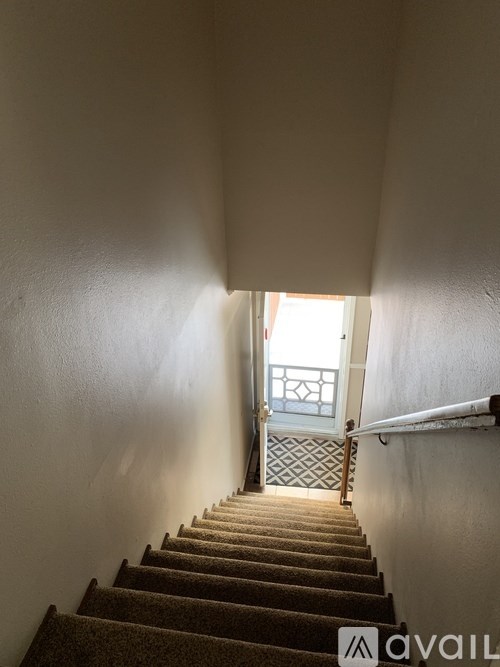 A staircase leading to a door with a window.