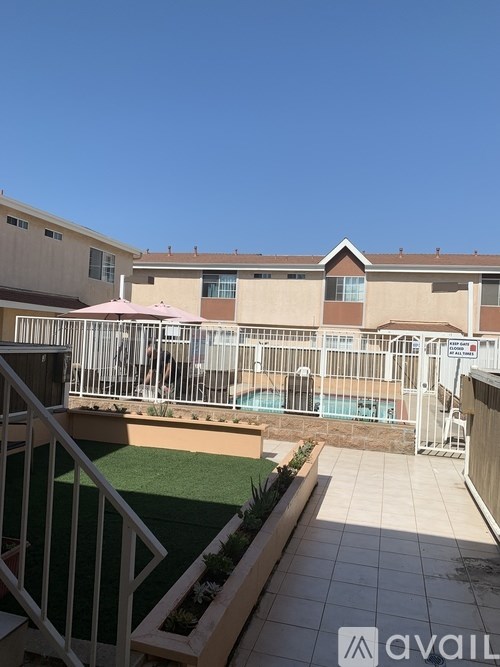 A sunny day at the pool with a building in the background.