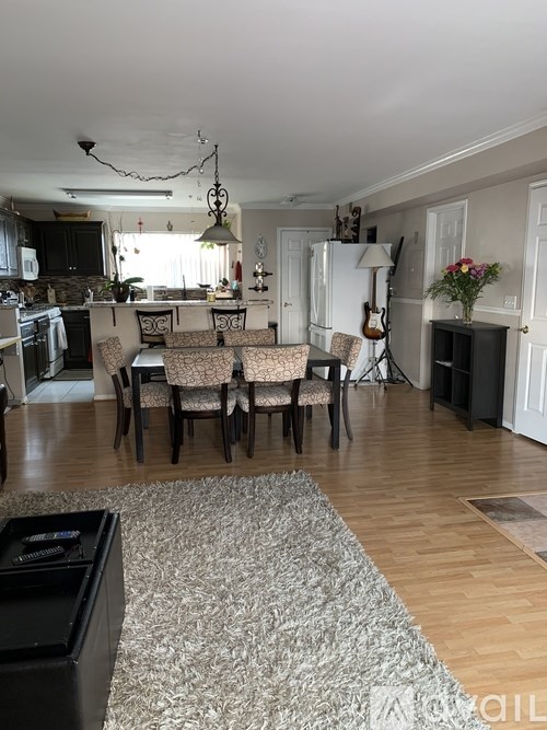A dining room with a table set for six.