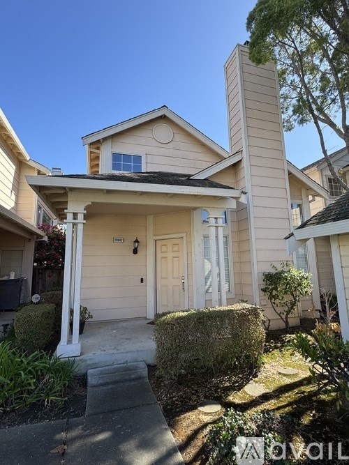 A house with a white door and a small window above it.