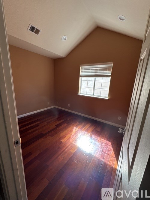 A room with brown walls and wooden floors.