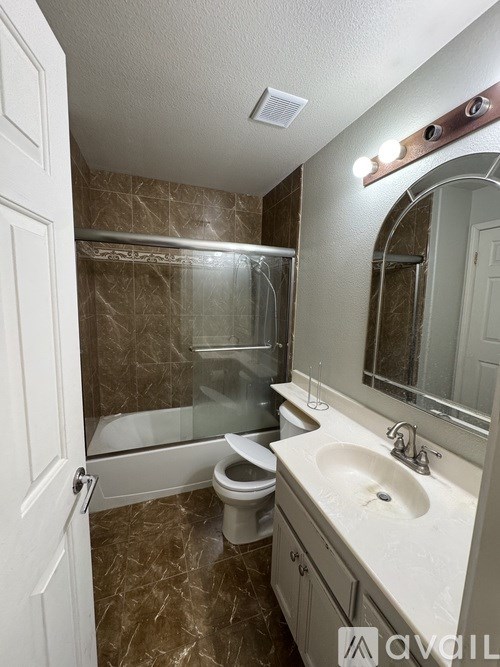A bathroom with a toilet, sink, and shower.