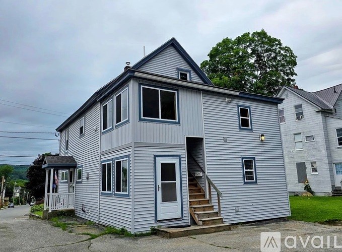 A two-story house with a blue door and windows.