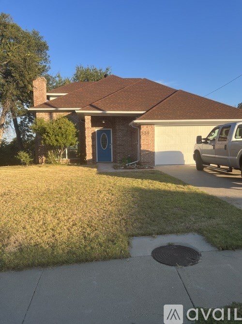 A house with a blue door and a white van parked in front.